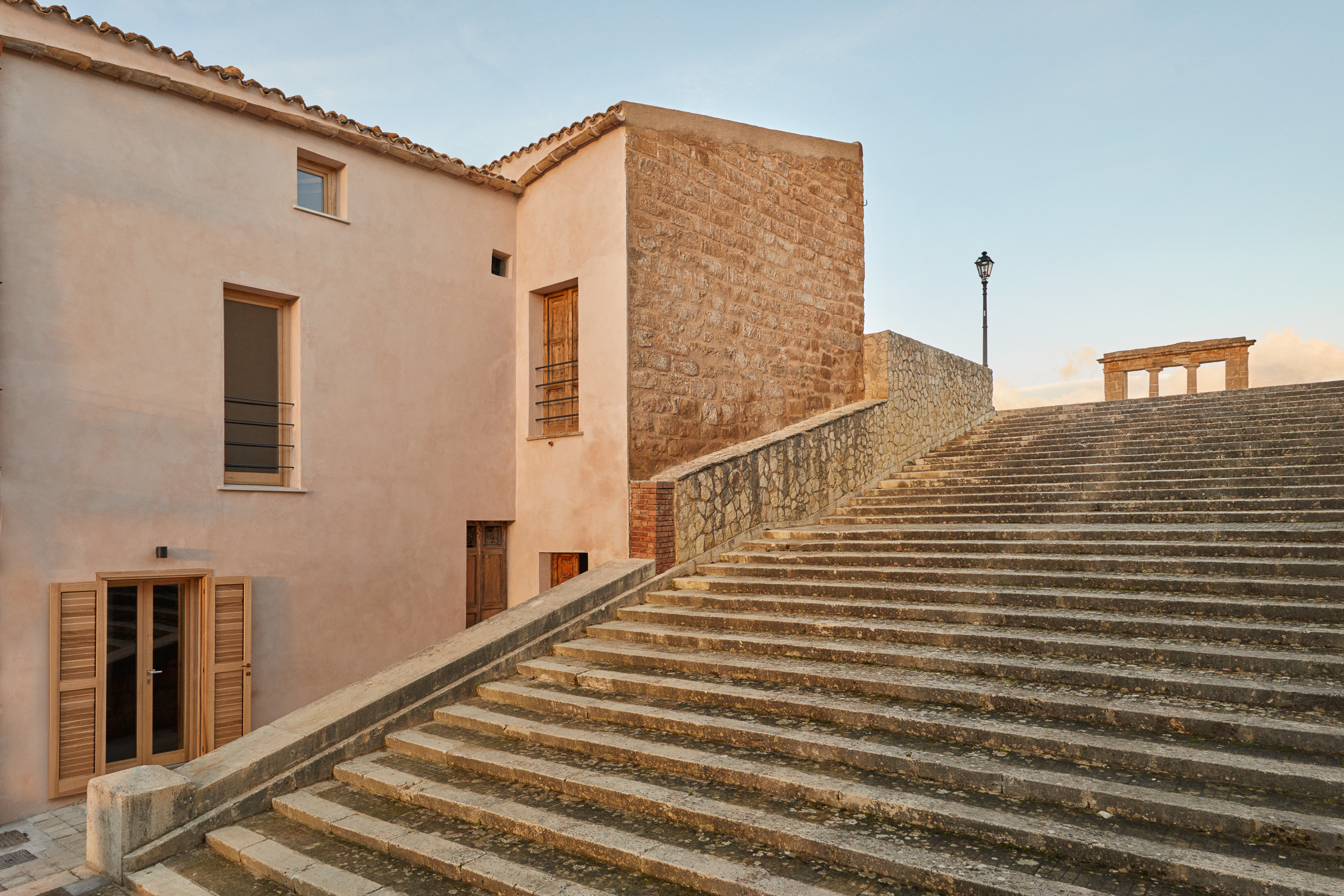 Exterior view of the renovated 1 Euro House in Sambuca, Sicily, showcasing the traditional architecture and modern updates.