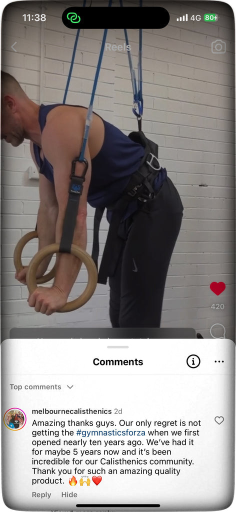 Gymnastics Forza equipment in a home gym setting, showcasing wooden rings and straps, ideal for bodyweight training.