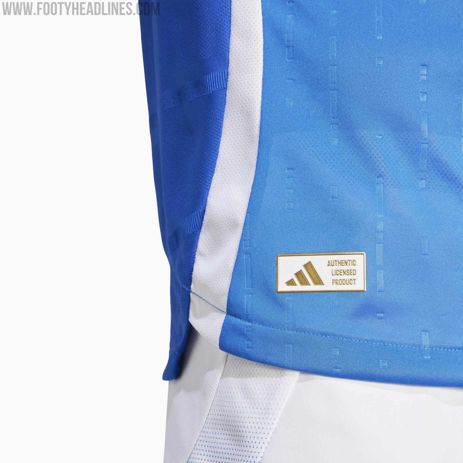 alt text: Close-up of the Italy Euro 2024 home kit, showcasing the intricate "I" pattern and the tricolor detailing on the shoulders.