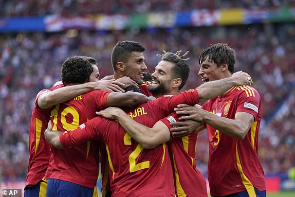 Spain players celebrate after Dani Carvajal, back to camera, scored their side